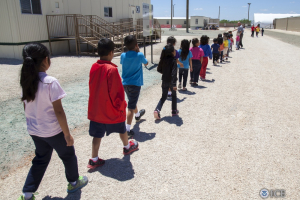 Children walk to classrooms at the South Texas Family Residential Center