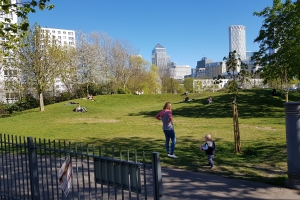 Social distancing in park, Docklands, London during coronavirus pandemic.