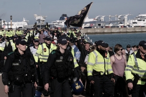 A small number of right wing anti-immigration protesters, escorted by police, take an afternoon stroll along Dover's seafront.