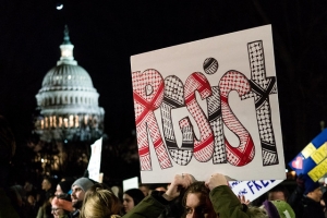 Resist sign, Supreme Court news conference to call for the reversal of President Trump’s travel ban on refugees and immigrants from several Middle East countries