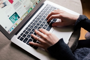 Girl is browsing Pinterest on her MacBook Air