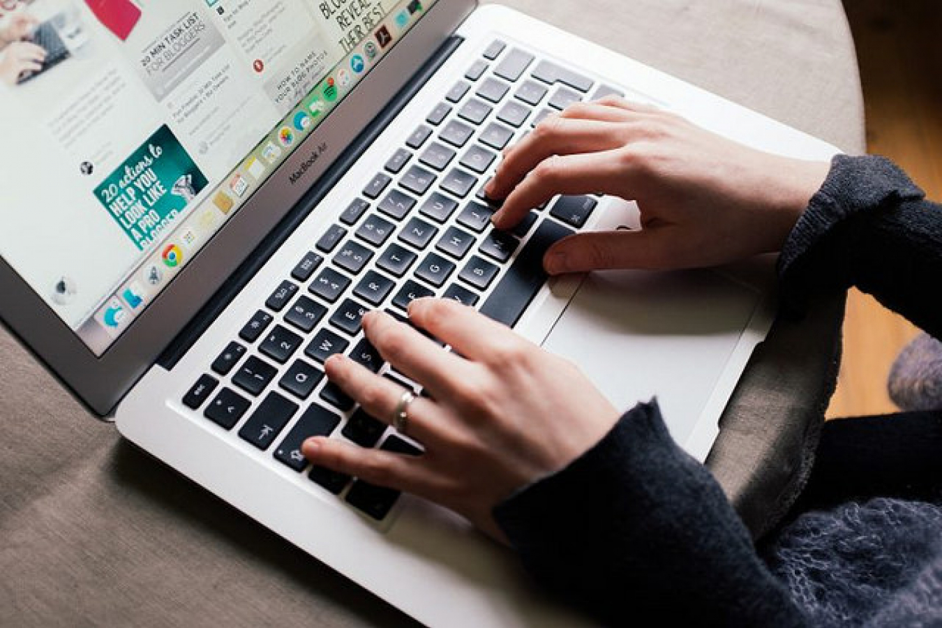 Girl is browsing Pinterest on her MacBook Air