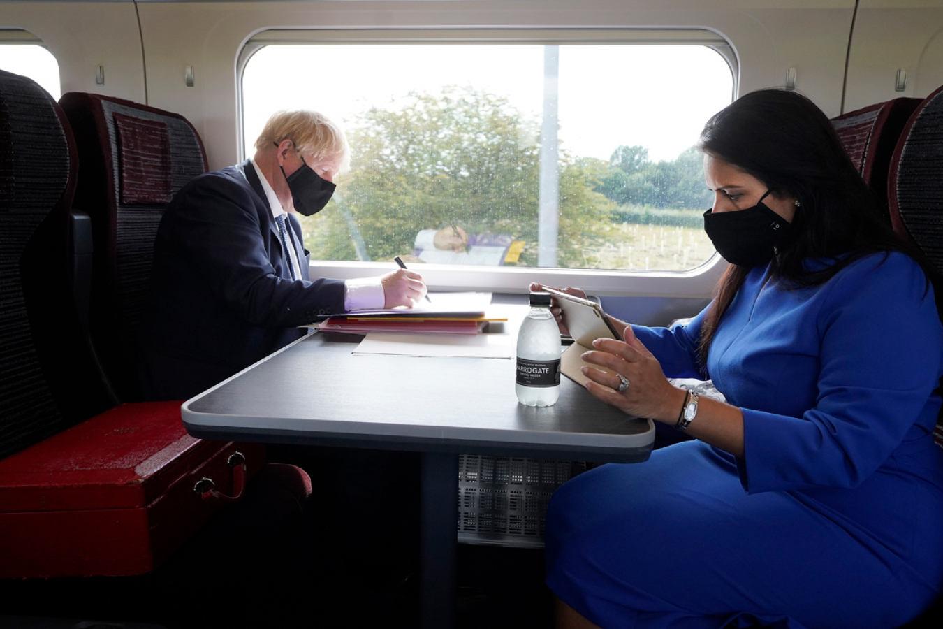 Boris Johnson and Priti Patel working on the Train